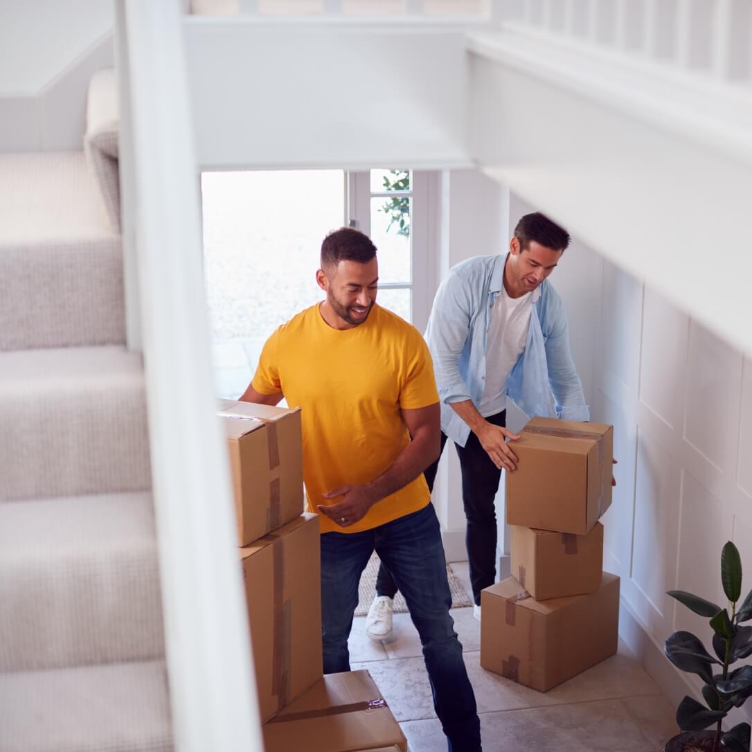 Image showing a couple moving boxes into their new home