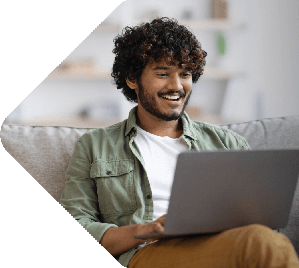 Image showing a man sitting on his couch using his laptop