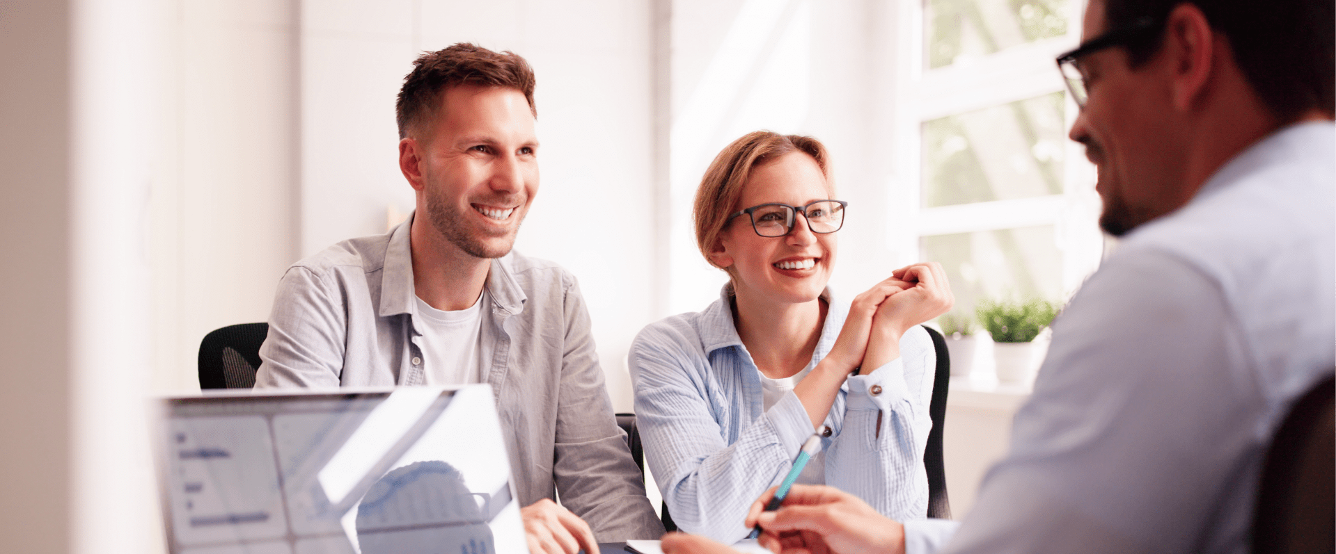 Image showing a man presenting a plan to a smiling man and woman