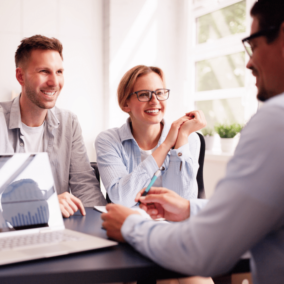 Image showing a man presenting a plan to a smiling man and woman