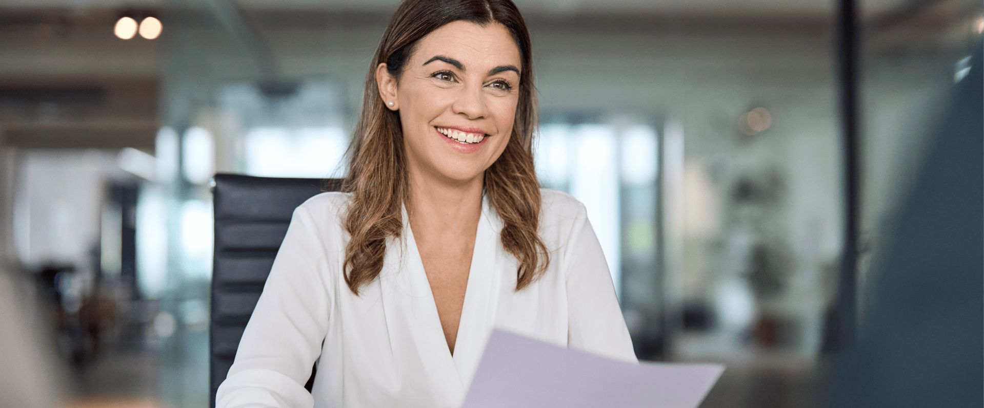 Image showing a woman smiling to a person, holding a piece of paper in her hands