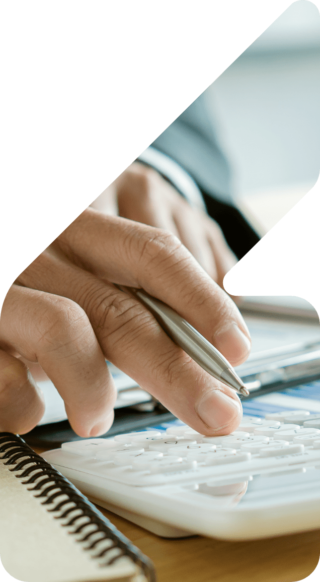 Image showing a man holding a pen and using a calculator to calculate