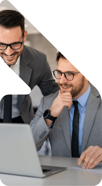 Image of two wealth managers over a laptop