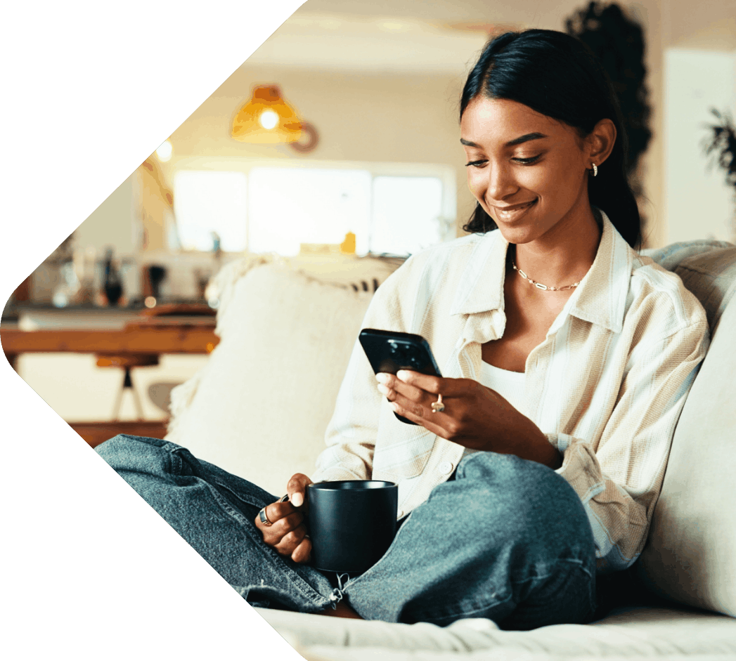 Image showing a woman sitting on a sofa and reading on her phone