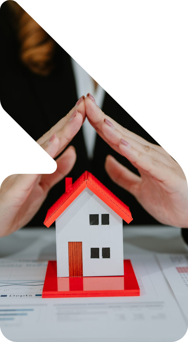 Image showing a close up of a woman using her hands to protect a model house